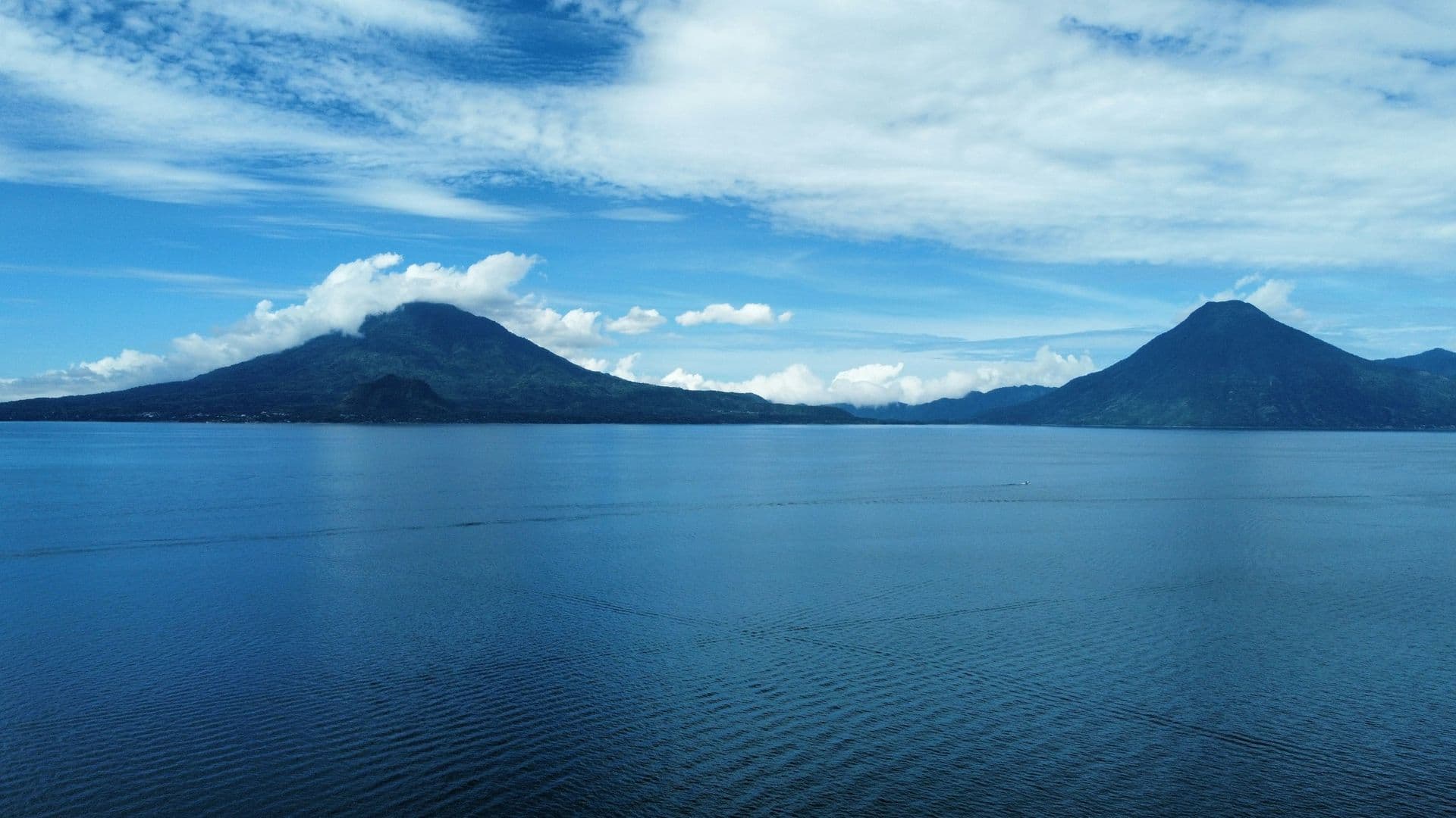 Volcanoes rising above the calm water of Lake Atitlán
