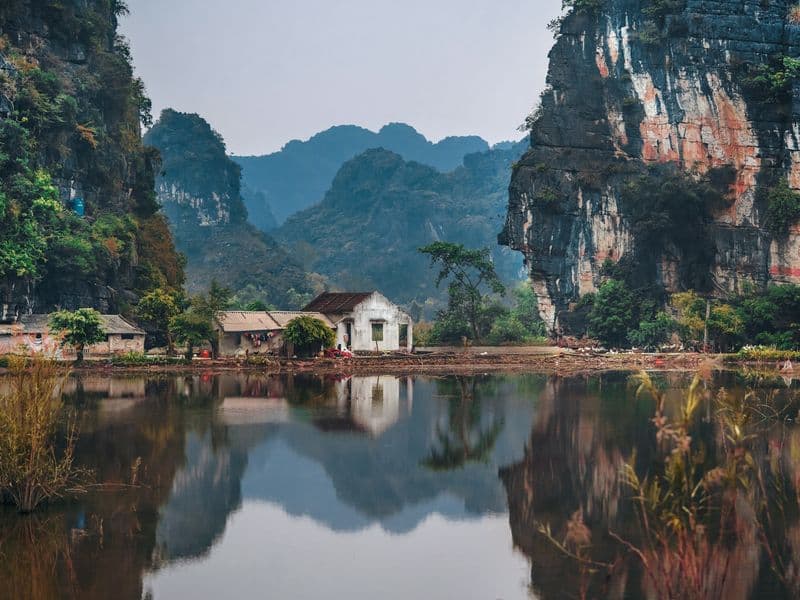 Limestone karst mountains reflected in still water in northern Vietnam